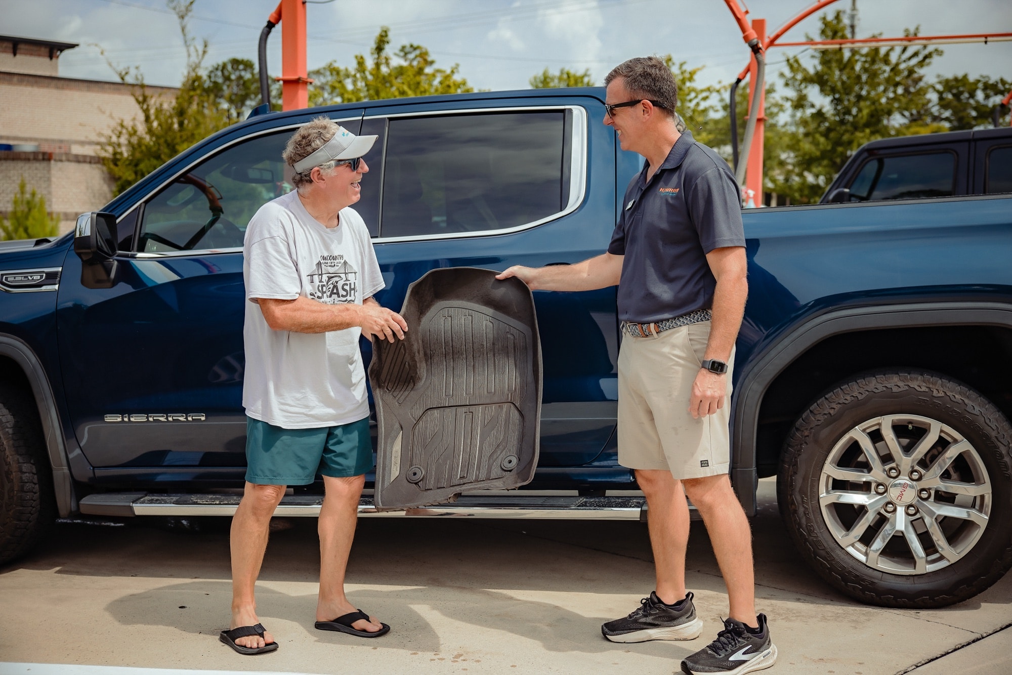 An H2Turbo owner handing a customer their floor mat back